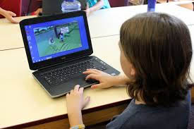 Boy with laptop and video game
